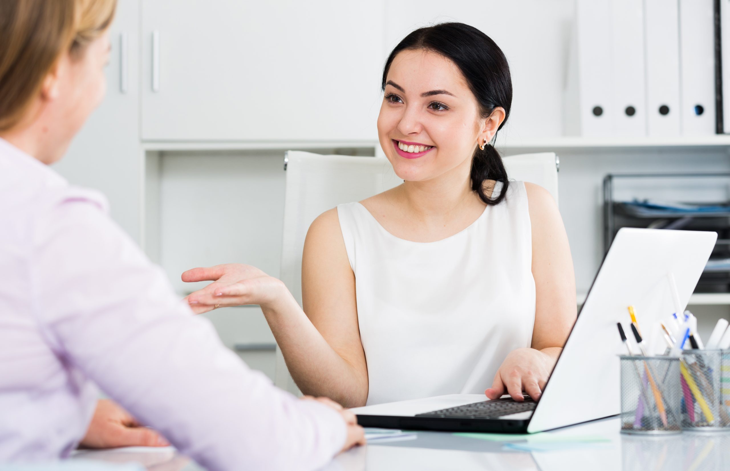 Woman at a deskt with client